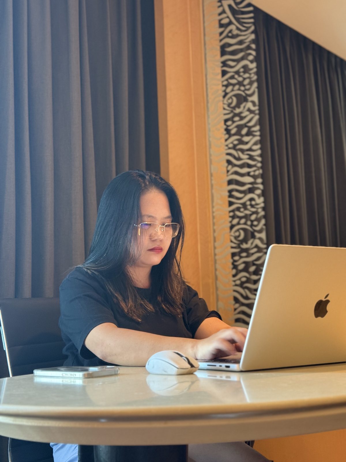 Jean Aguilar, founder of PinoyRemote, working on her MacBook in Cavite